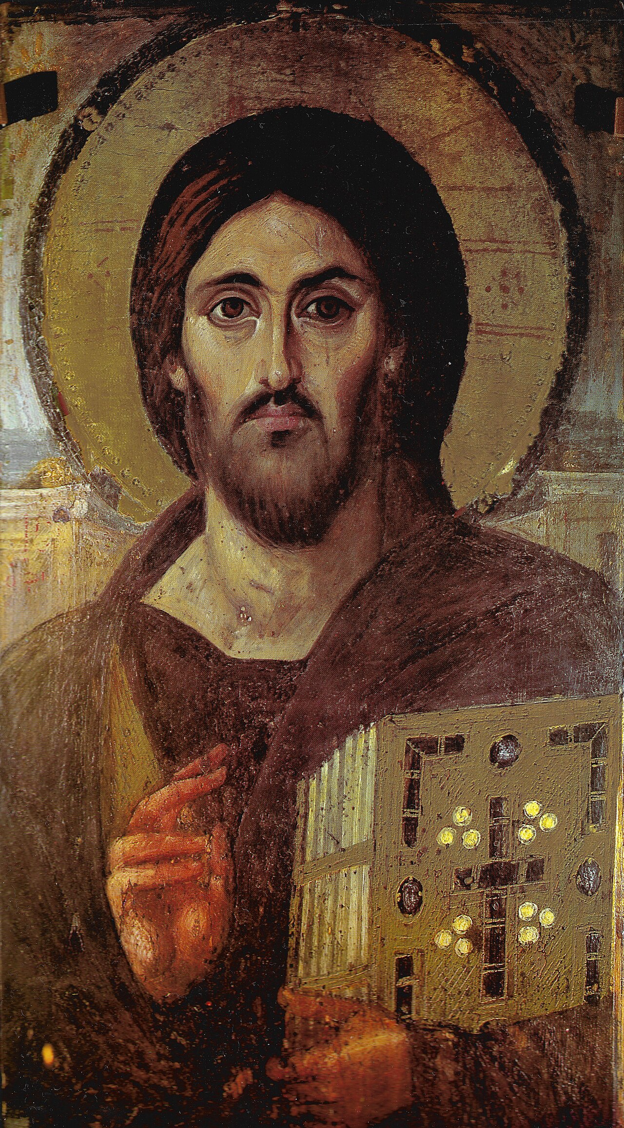 The sixth-century encaustic icon of Christ Pantocrator from Saint Catherine's Monastery, Sinai: Christ blessing with one hand and holding a jeweled Gospel book in the other.
