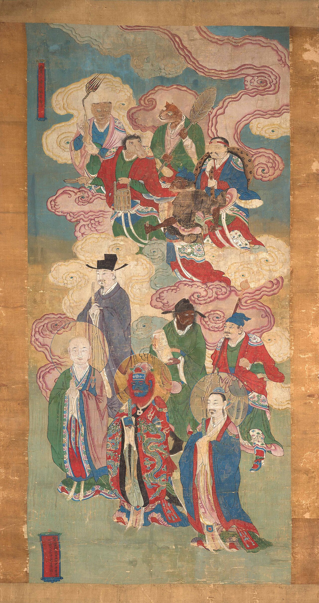 A tall Qing-dynasty Water-Land hanging scroll shows ranked Buddhist and Daoist divinities descending in clouds, painted in mineral colors on silk.