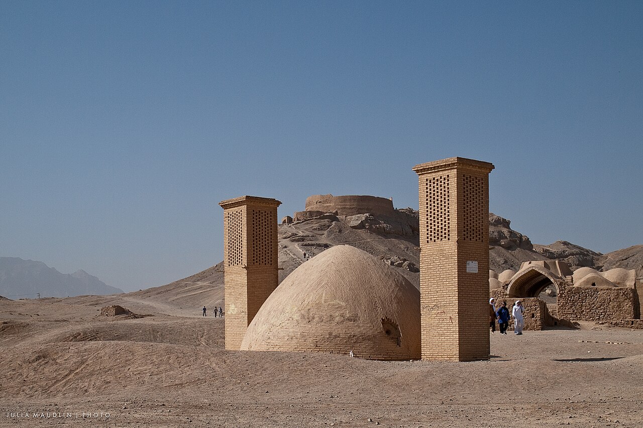 The Towers of Silence outside Yazd: wind towers and the ice-house dome in the desert below the dakhma hill.