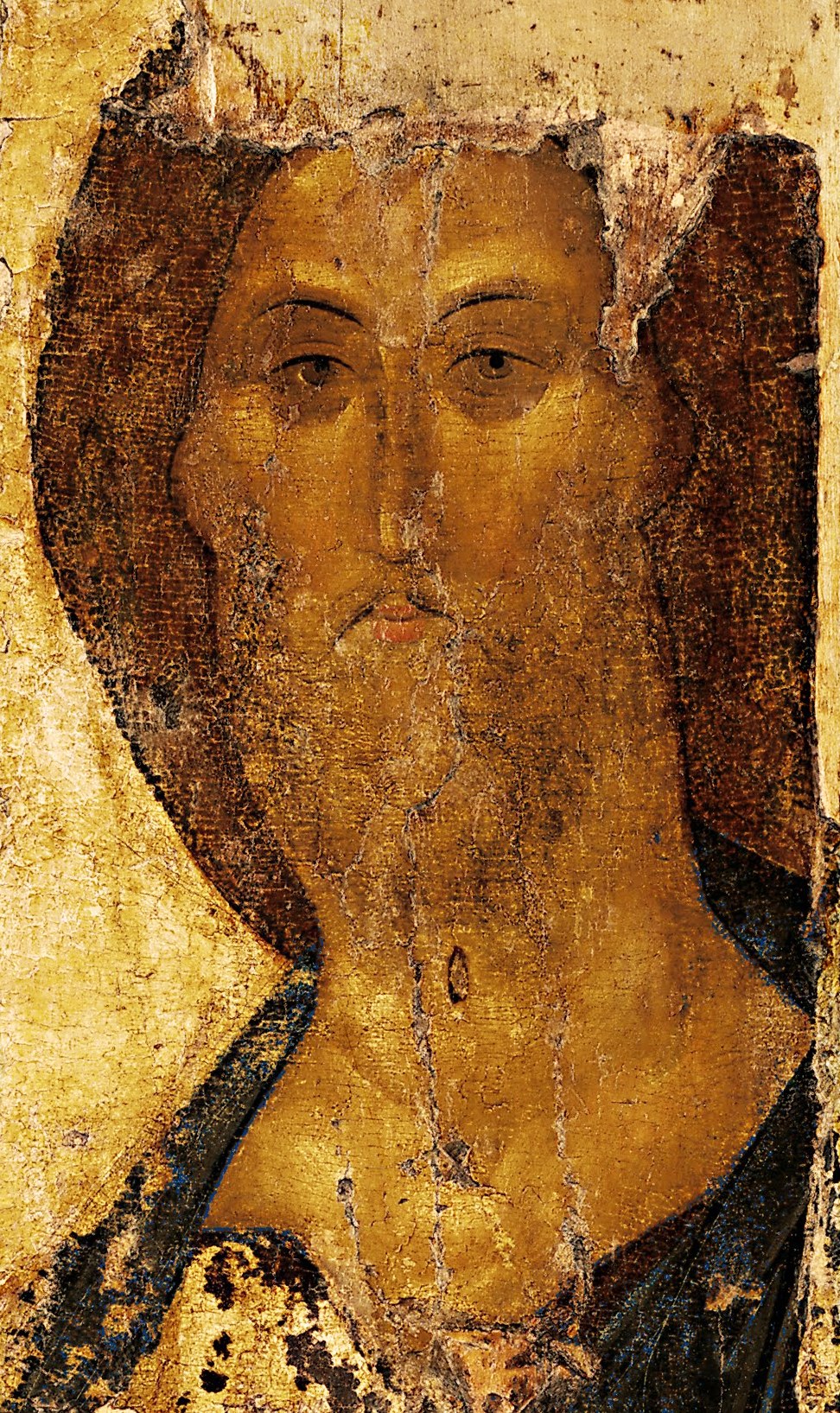 The aged, gold-toned face of Christ from Andrei Rublev's Saviour icon from Zvenigorod, its paint worn and cracked.