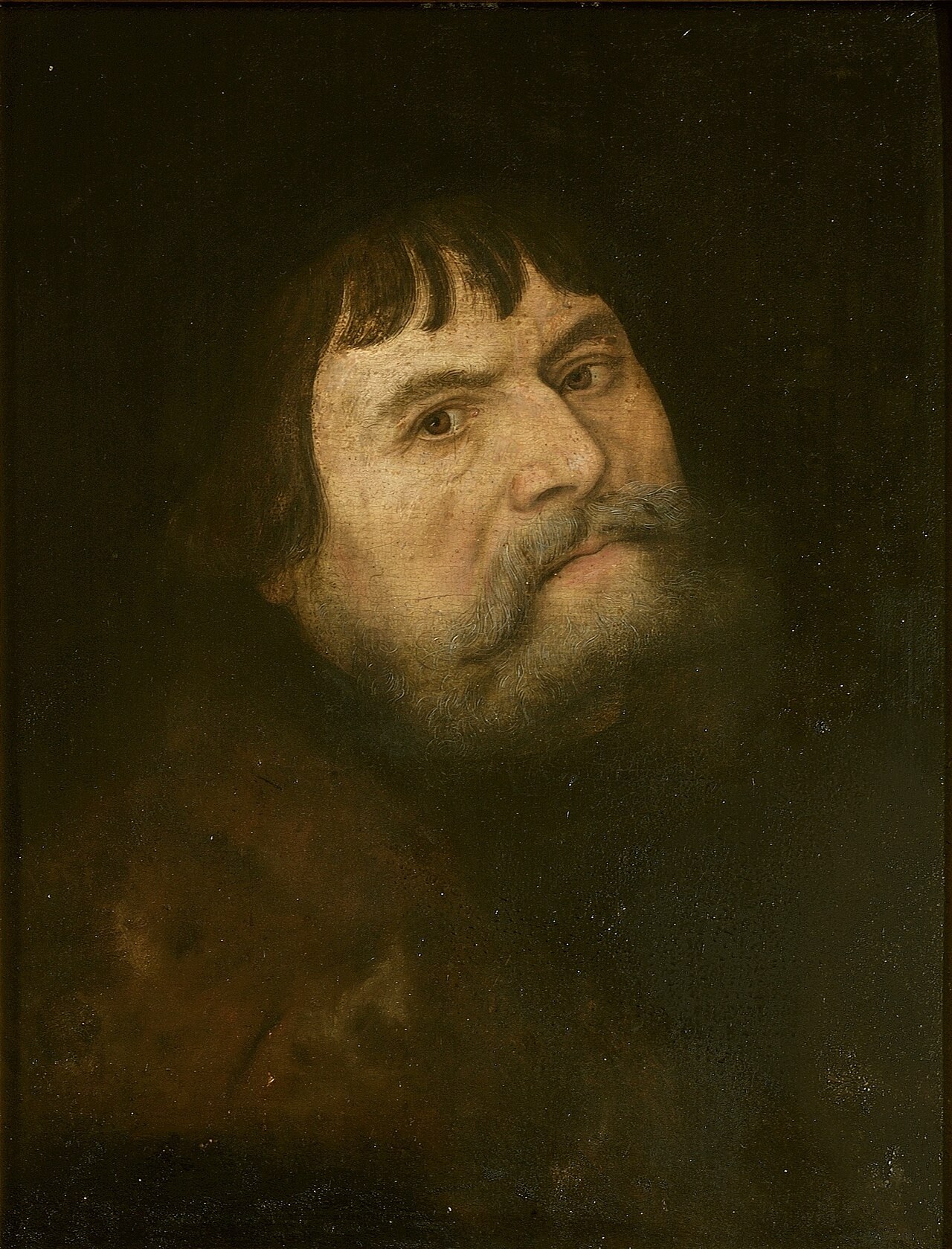 Lucas Cranach the Elder's painted self-portrait: his bearded head in three-quarter view against a dark background.