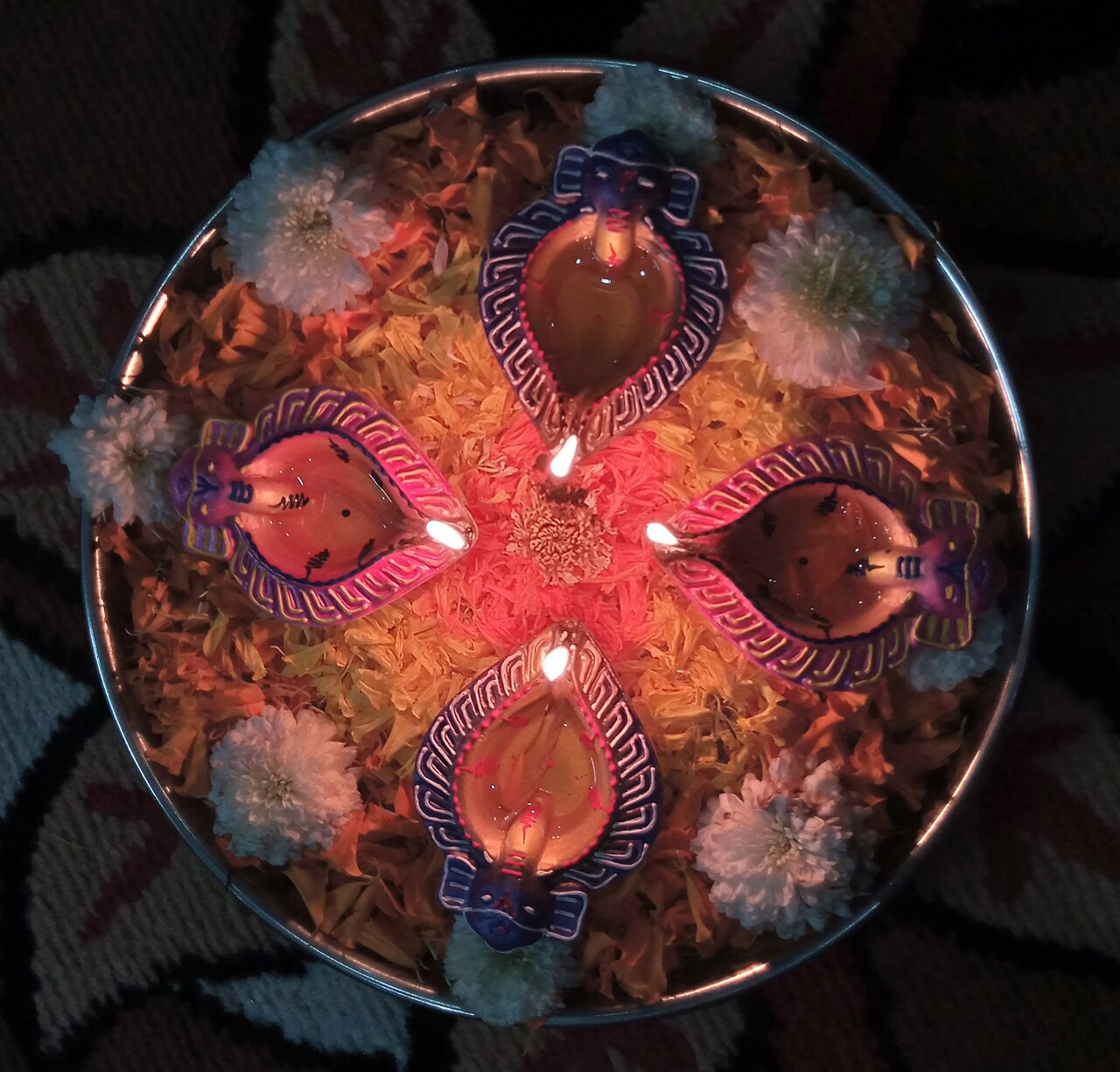 Clay diyas burning in rows at Diwali.