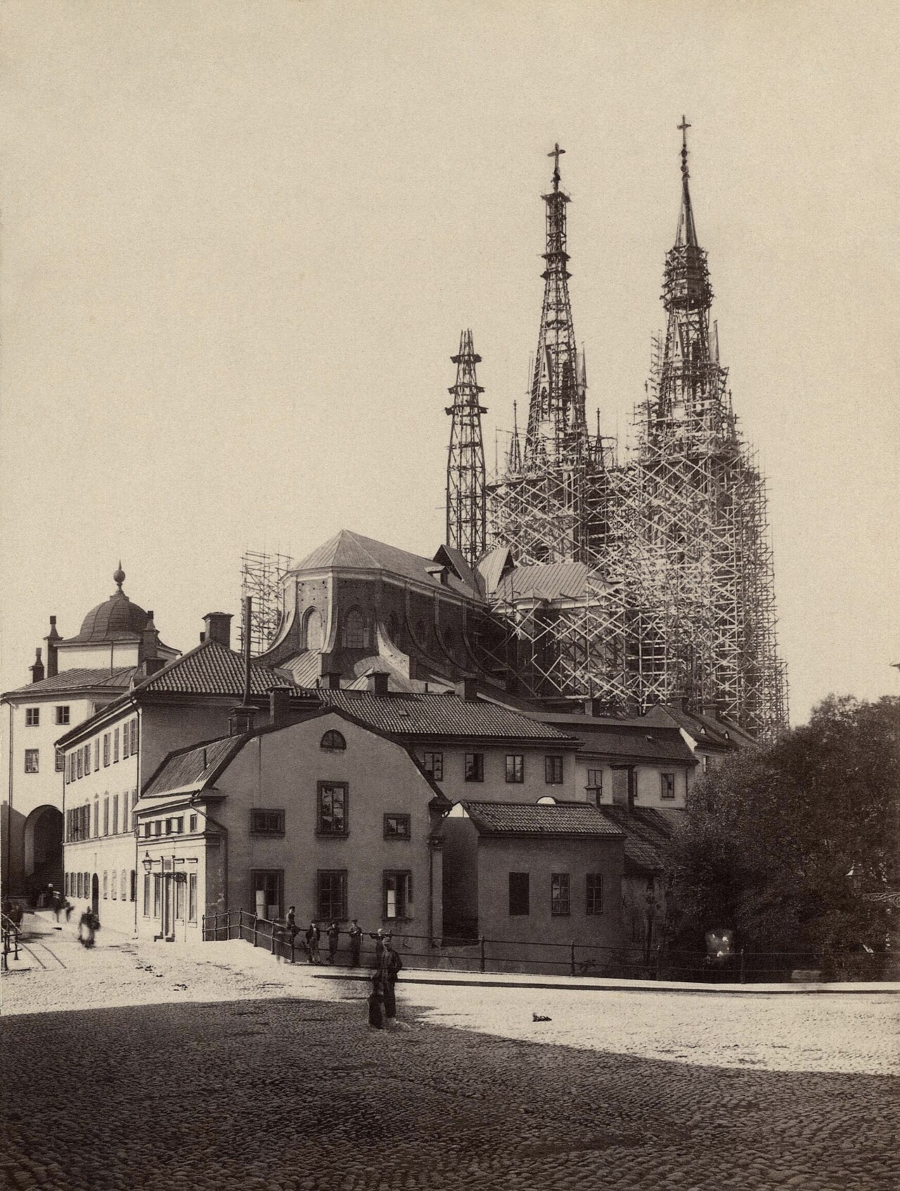 A sepia 1889 photograph of Uppsala Cathedral's twin spires above the old town.