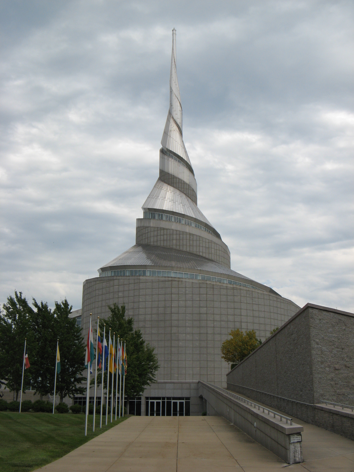 The spiraling shell spire of the Community of Christ Temple in Independence, Missouri, under grey cloud.