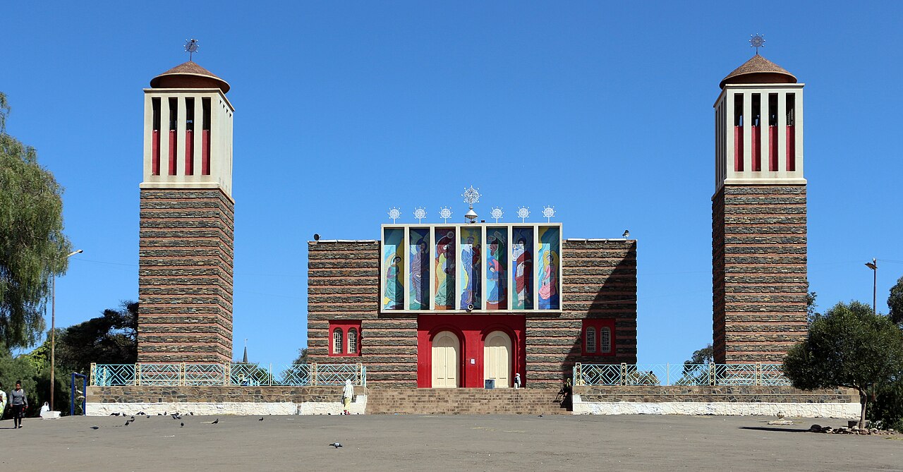 Asmara's Enda Mariam Orthodox Cathedral, its patterned twin towers and icon banners facing the square.