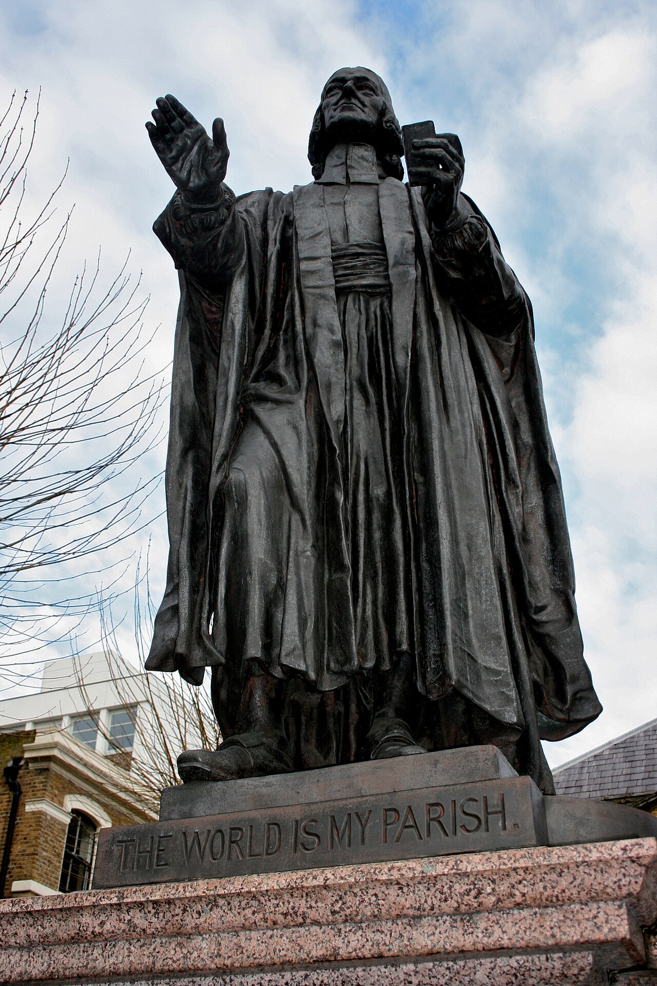 The bronze statue of John Wesley, arms raised in preaching, outside Wesley's Chapel in London.