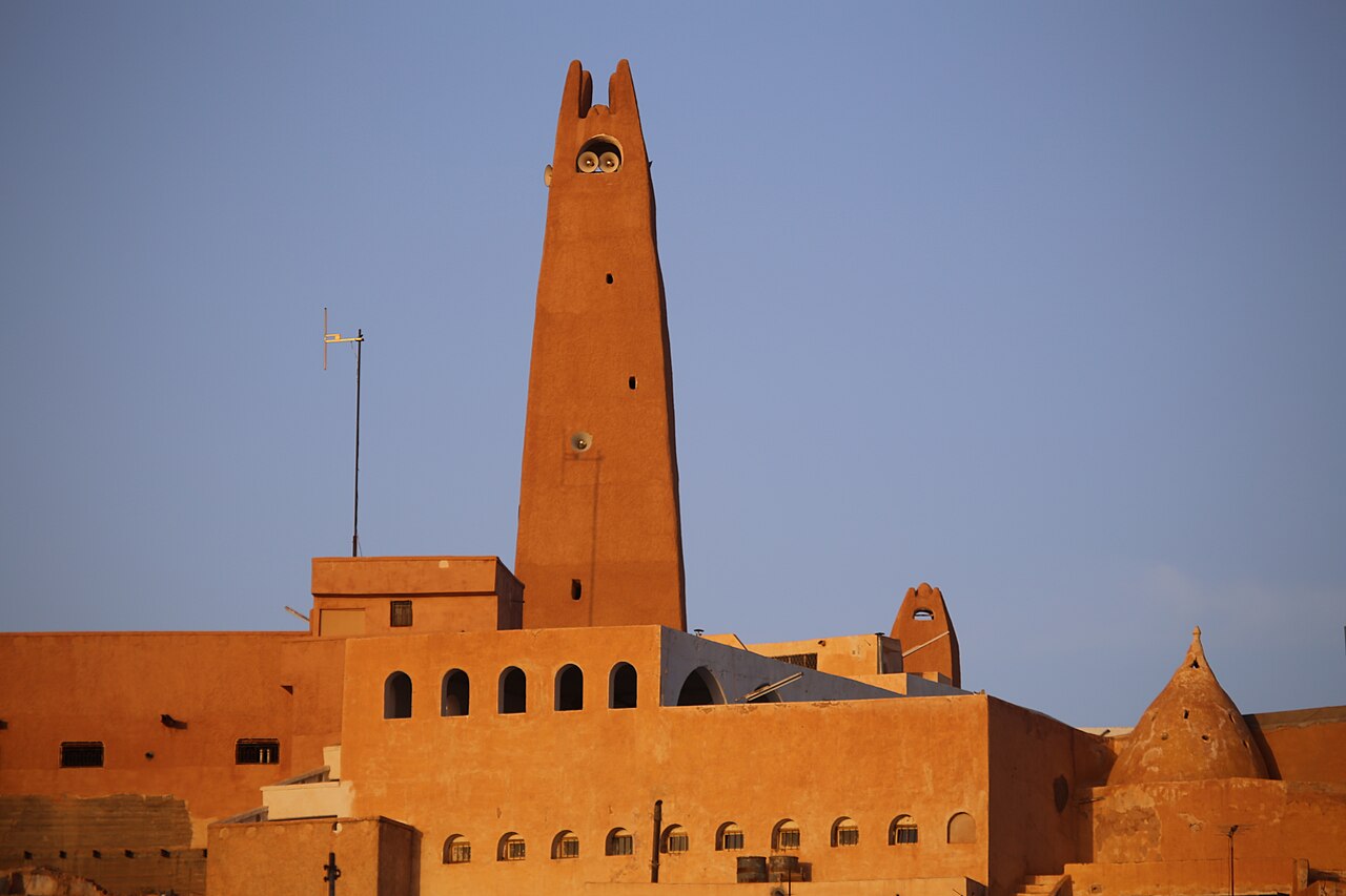 The Great Mosque of Ghardaïa in Algeria's Mzab valley, its tall tapering mud-brick minaret rising over the rooftops of the ksar.