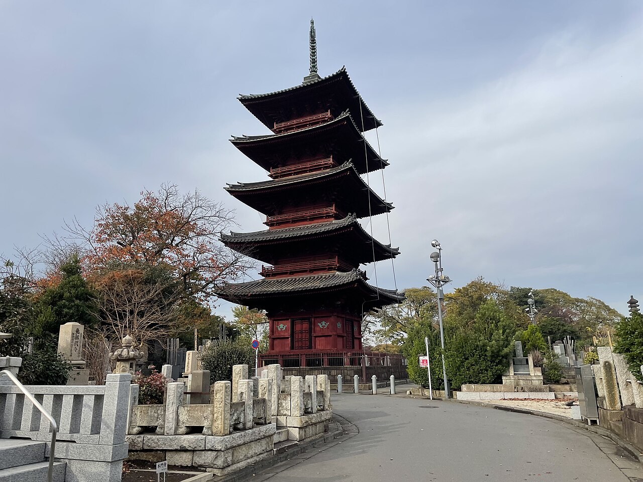 The red five-storied pagoda of Ikegami Honmon-ji in Tokyo rises above the temple road.