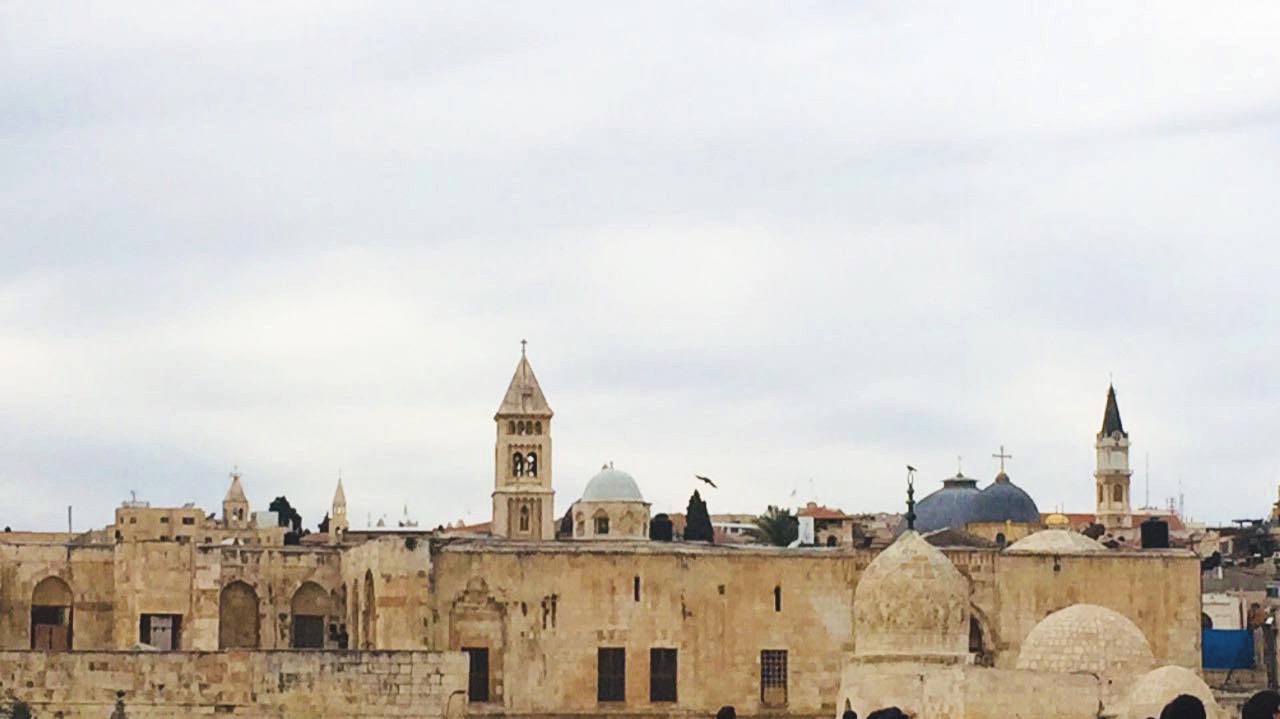 Rooftops, domes, and a church tower crowd the skyline of Jerusalem's Old City.