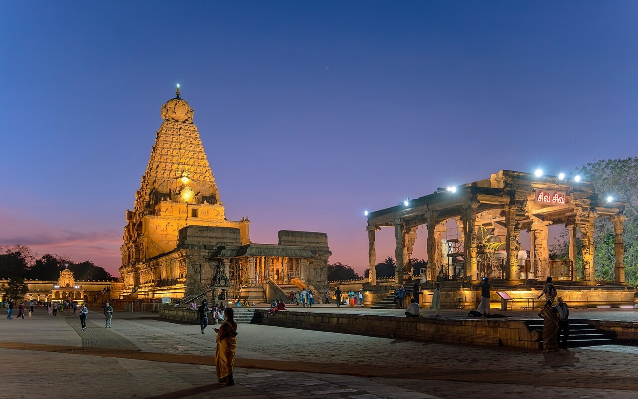 At dusk the floodlit golden vimana of the Brihadeeswarar Temple in Thanjavur glows against a violet sky.