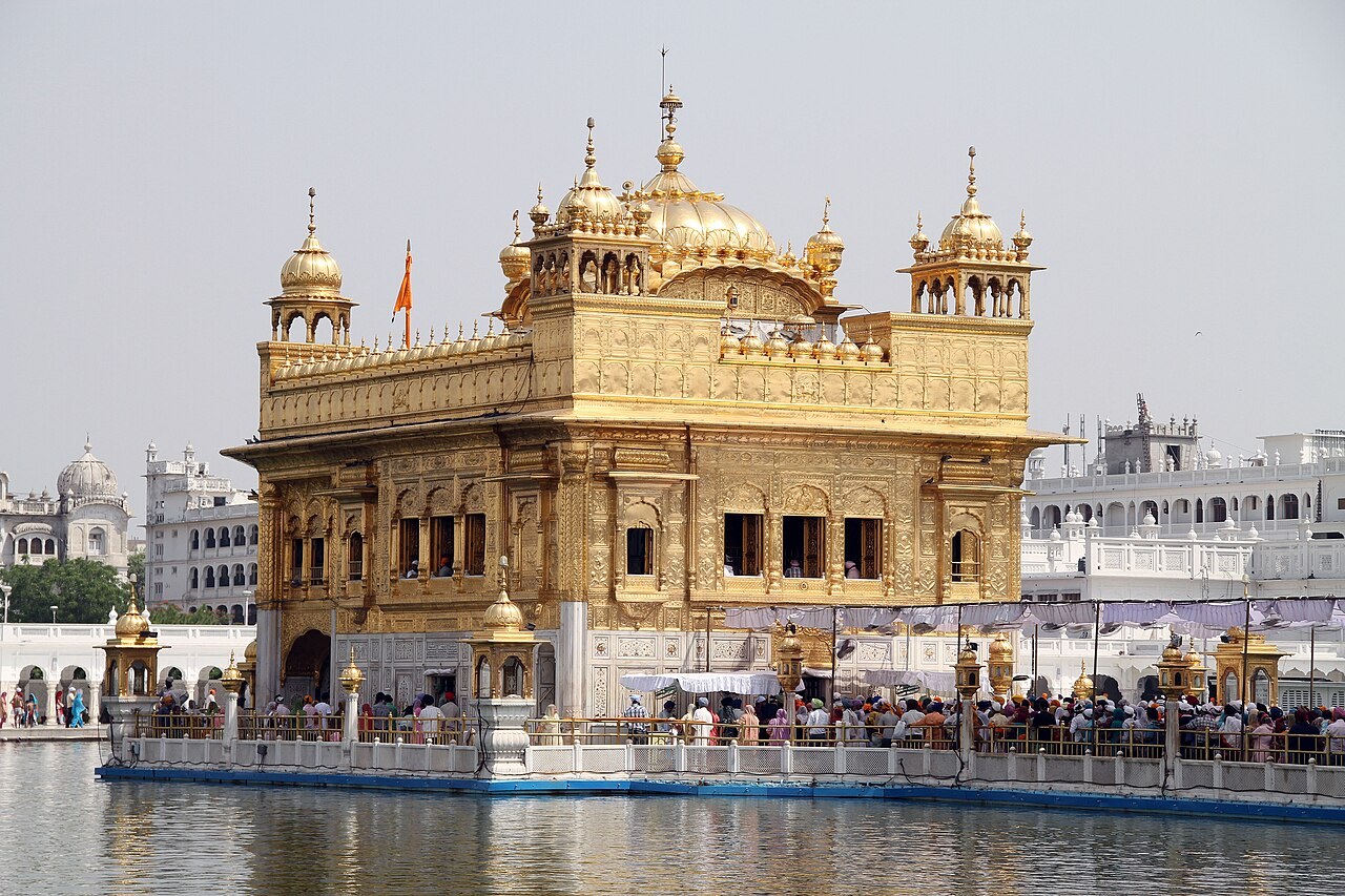 The golden Harmandir Sahib, the Golden Temple at Amritsar, stands in its sacred pool among pilgrims.