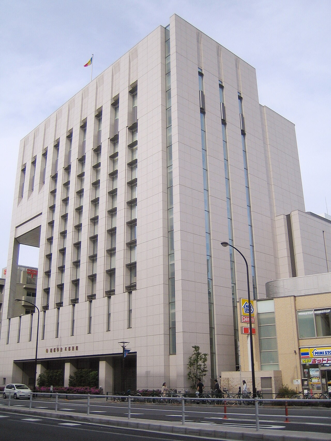 Soka Gakkai's modern white head-office building rises above a Tokyo street.