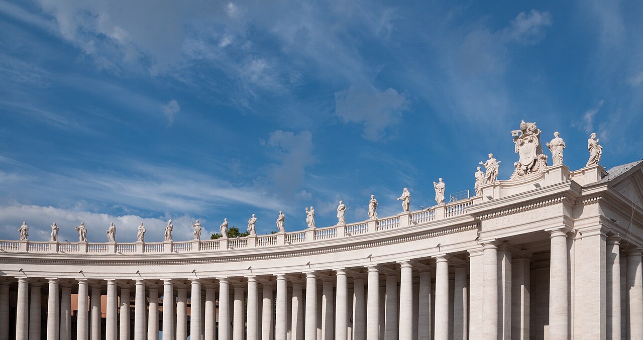 The north colonnade of St Peter's Square in Vatican City, lined with statues of saints.