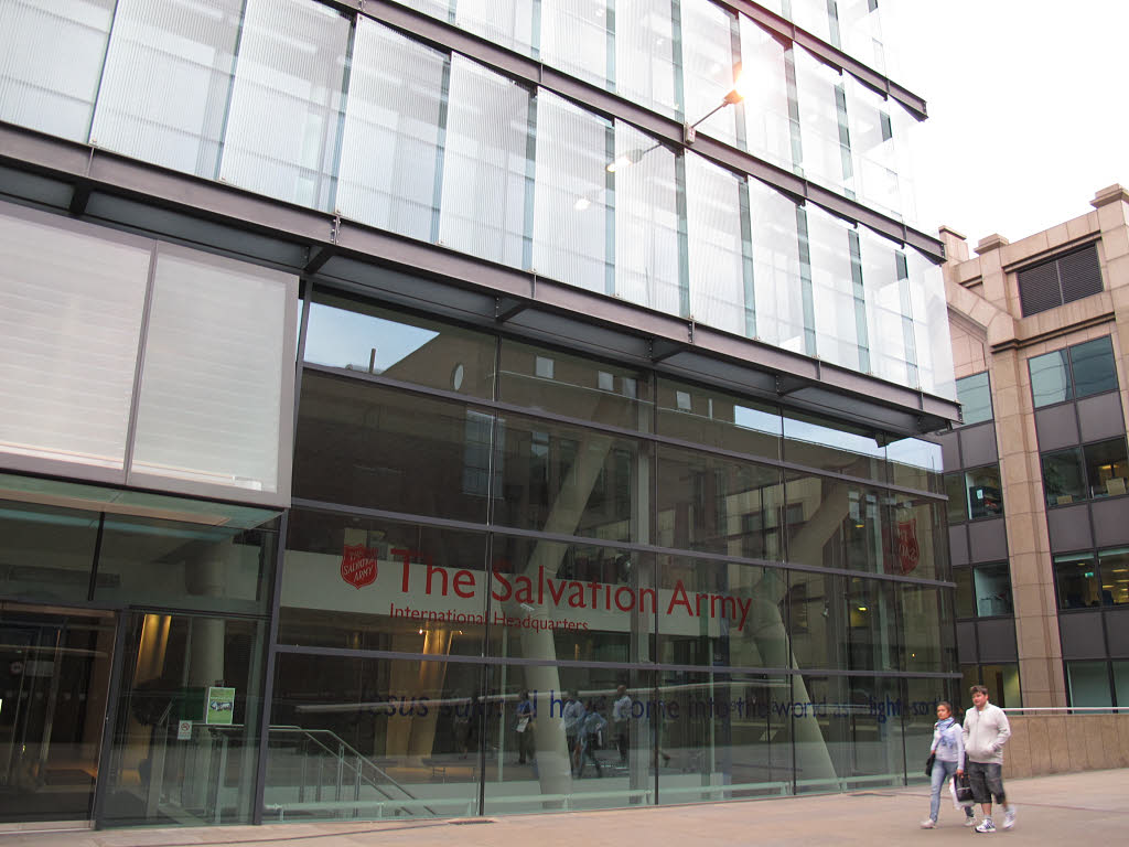 The glass entrance of The Salvation Army's International Headquarters in London, its name in red above the doors.
