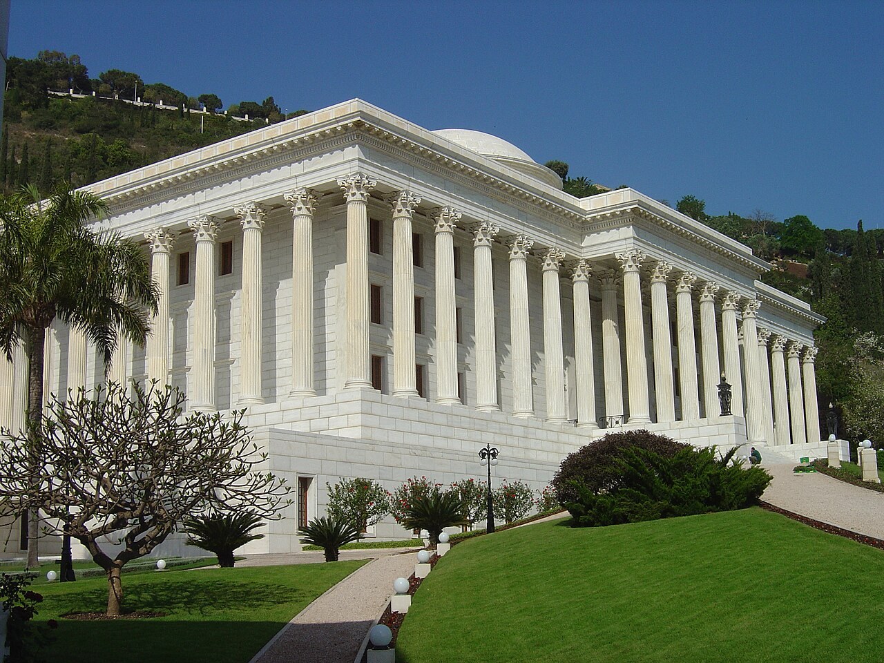 The white colonnaded Seat of the Universal House of Justice on Mount Carmel in Haifa rises above manicured gardens.