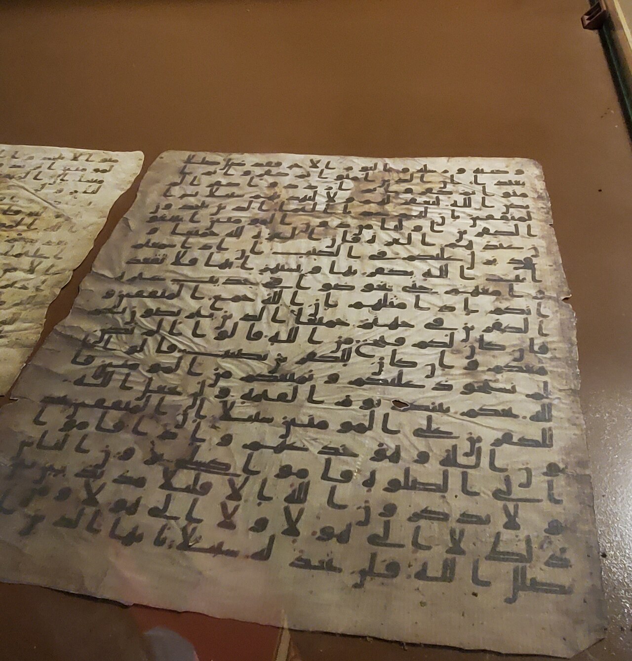 An ancient Qur'an parchment written in unpointed Kufic script, from the library of the Great Mosque of Sana'a in Yemen.