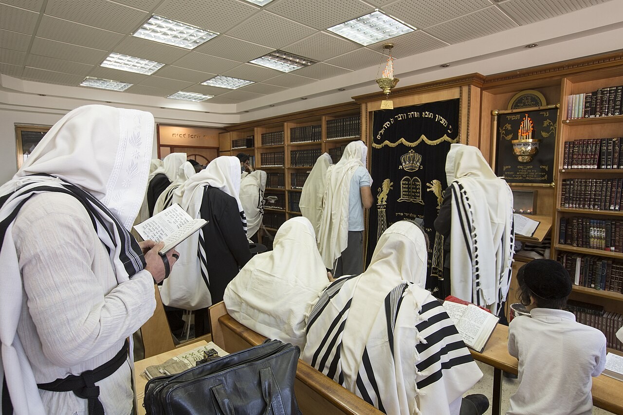 A Jewish man wrapped in a tallit at morning prayer in Safed.