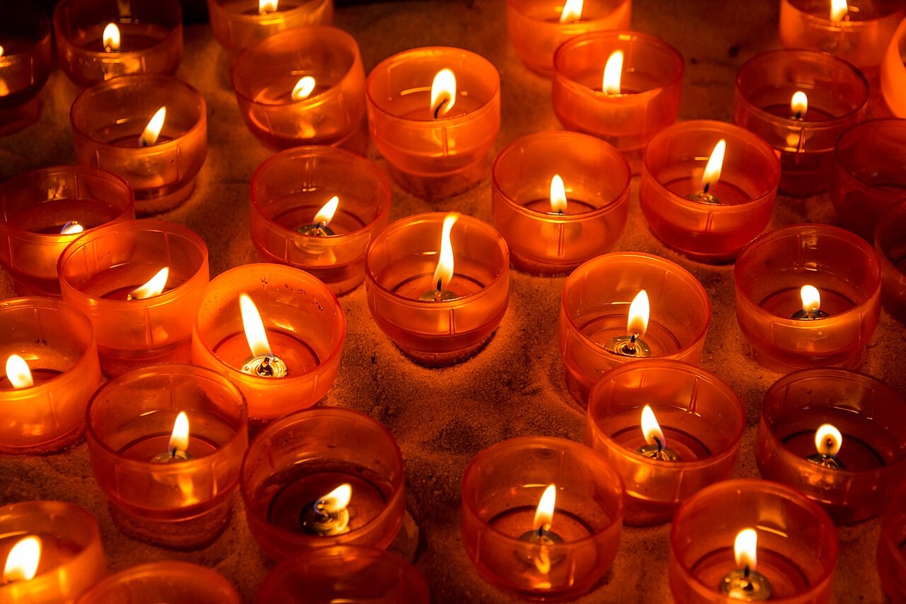 Rows of lit votive candles in the Marienkapelle chapel in Dülmen, Germany.