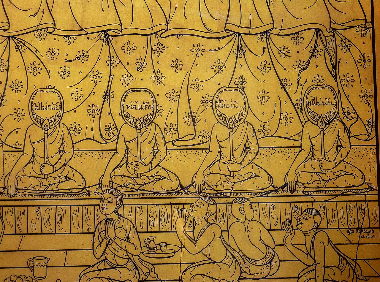 A chapter of Buddhist monks chanting together in a temple.