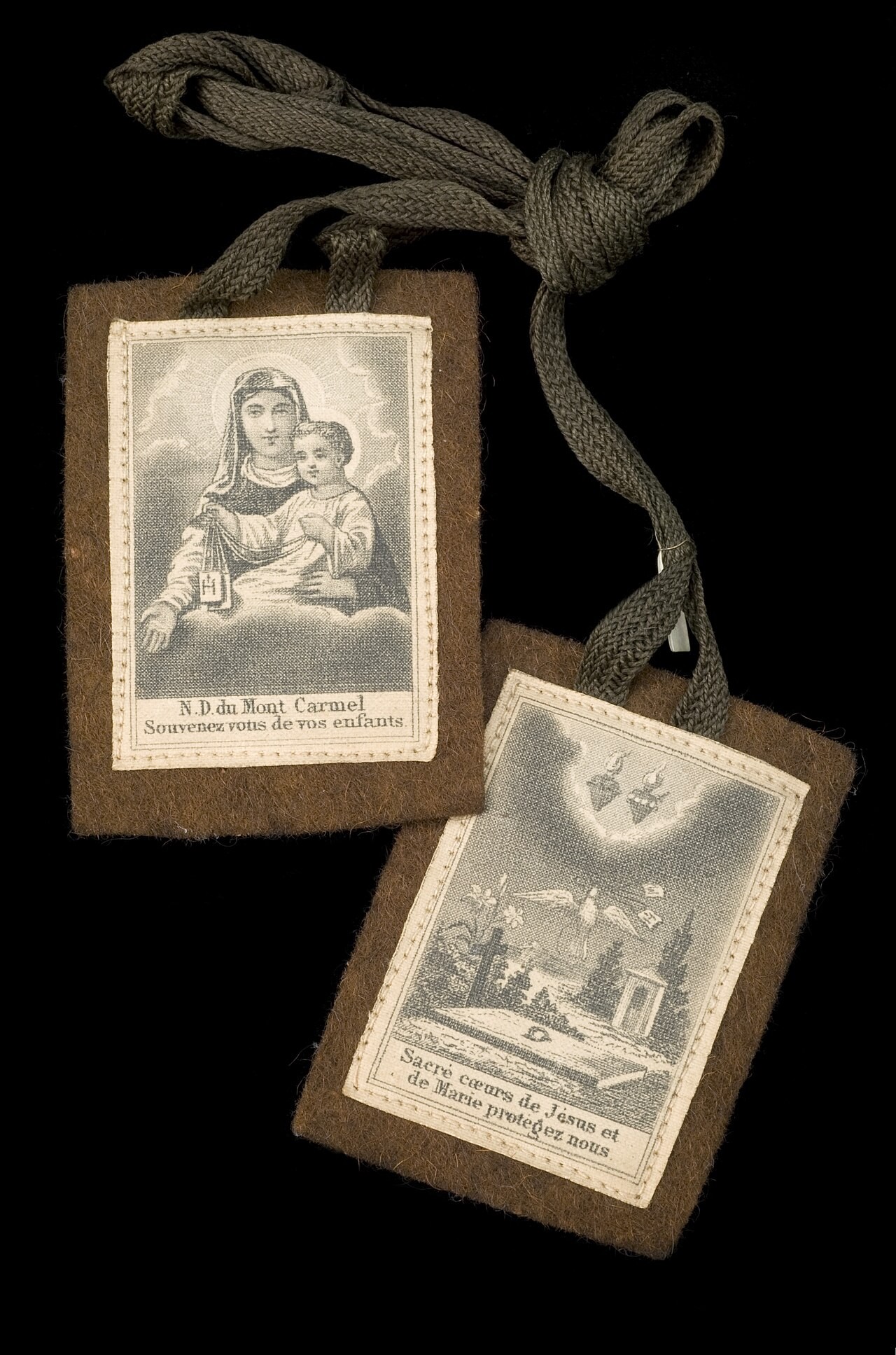 A brown scapular of Our Lady of Mount Carmel, showing its two wool panels and cords.