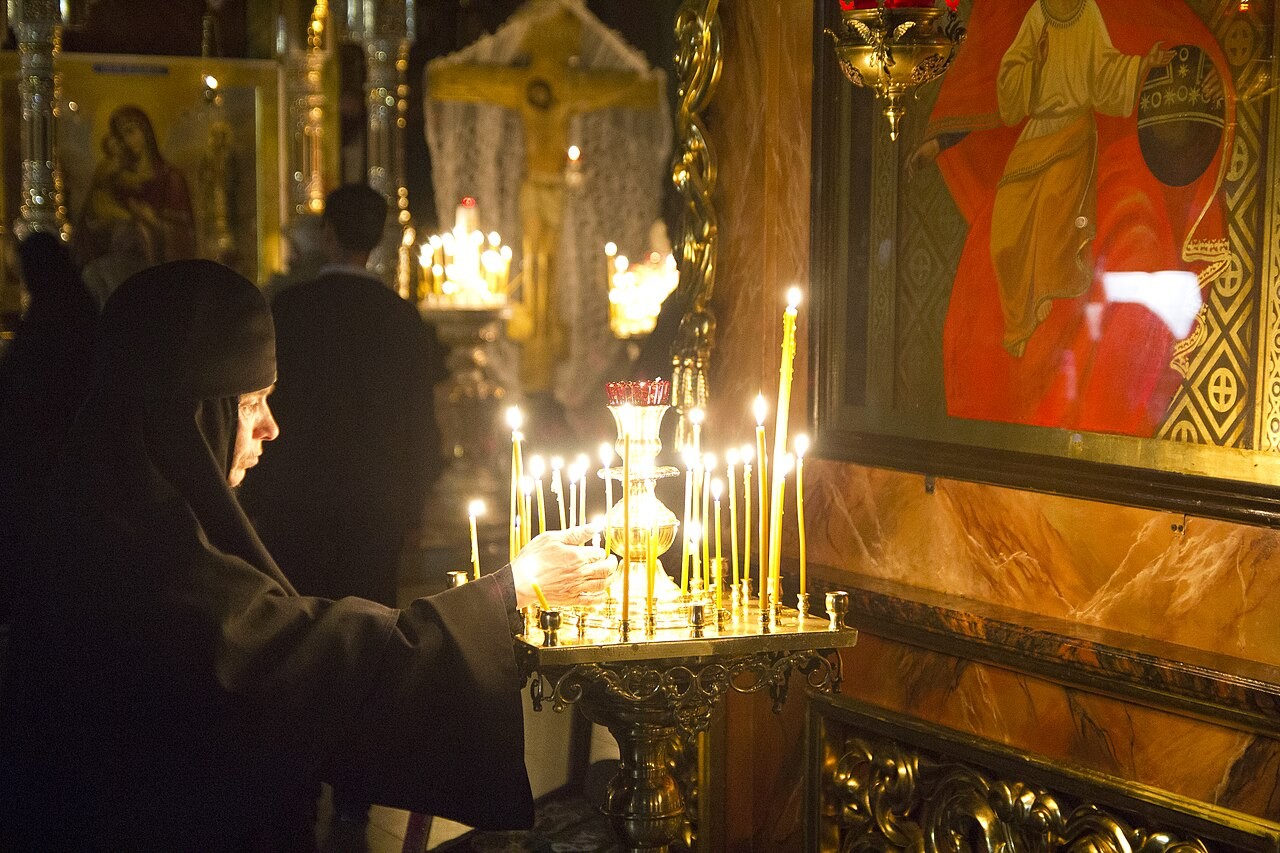 Candles burning before icons in an Eastern Orthodox church.