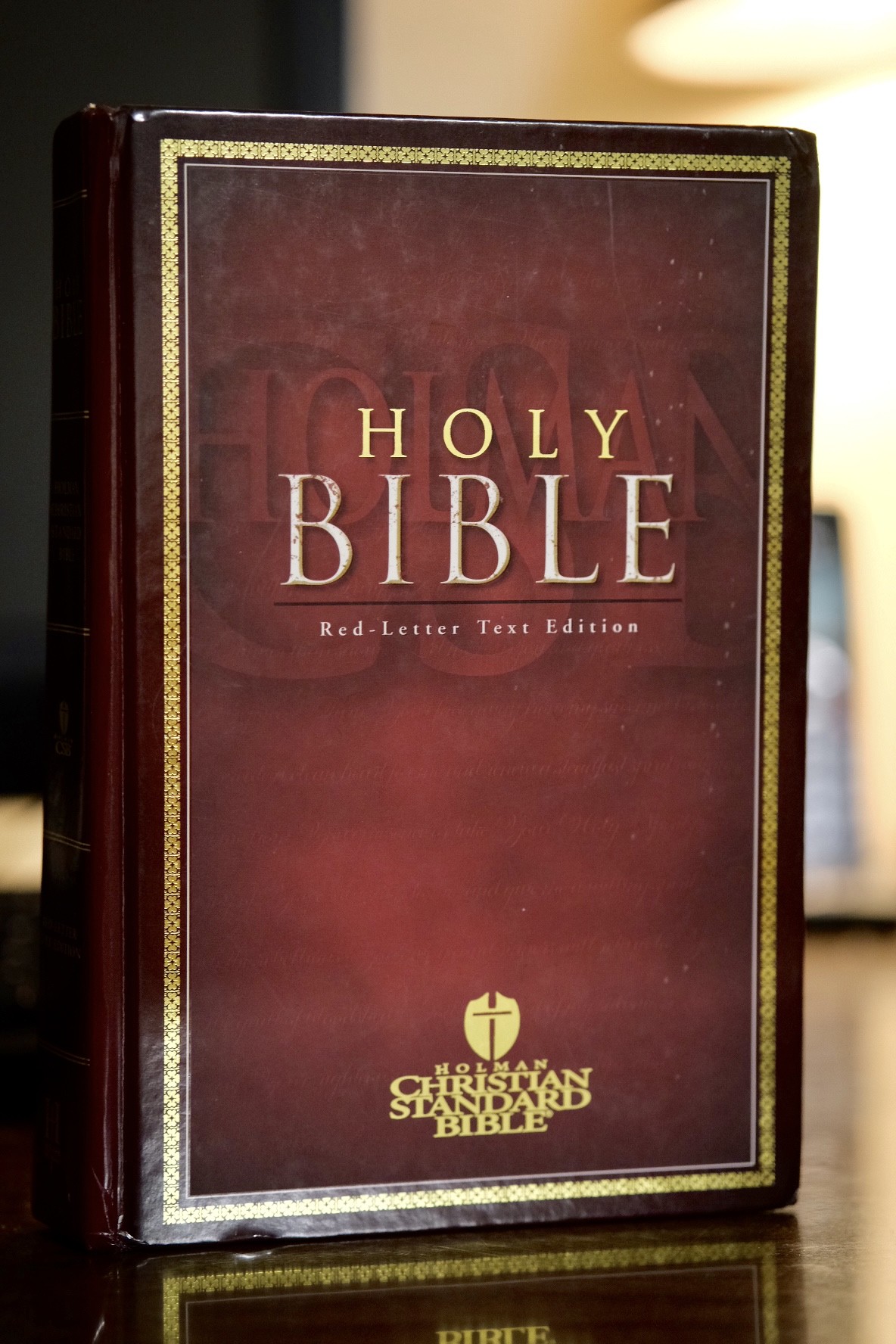A red leather Holman Christian Standard Bible with 'Holy Bible' and the Christian Standard Bible emblem stamped in gold on the cover.