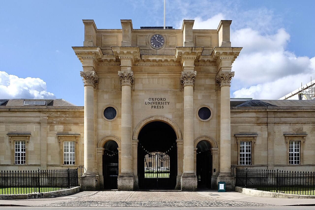 The Walton Street gateway of Oxford University Press in Oxford, a classical stone archway with the Press's name carved above the entrance.