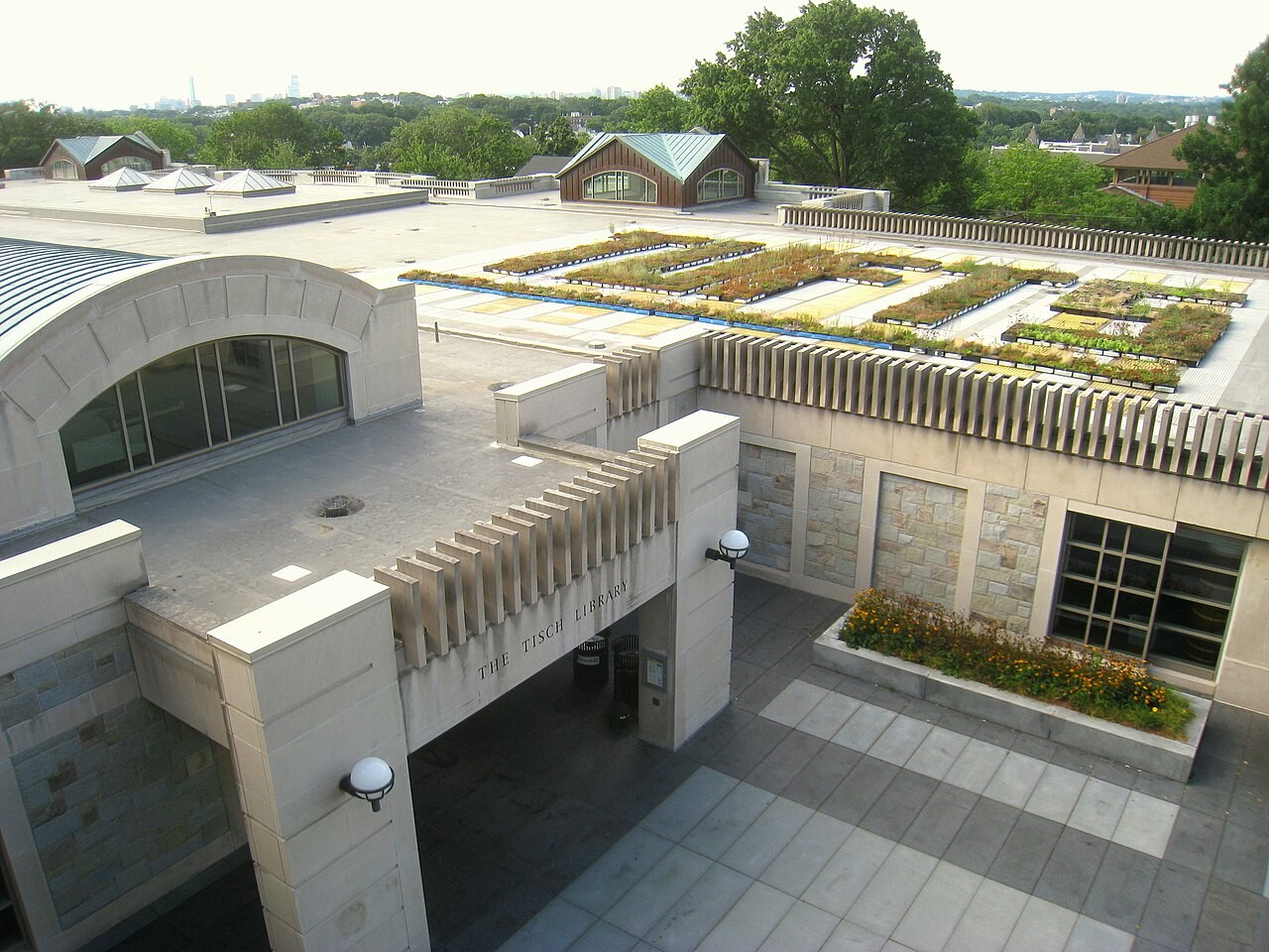 The Tisch Library at Tufts University seen from above, its green rooftop garden and courtyard surrounded by the library's modern wings.