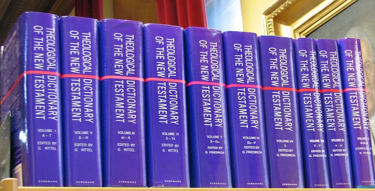 A row of blue hardcover volumes whose spines read 'Theological Dictionary of the New Testament,' the English edition of Kittel's dictionary.