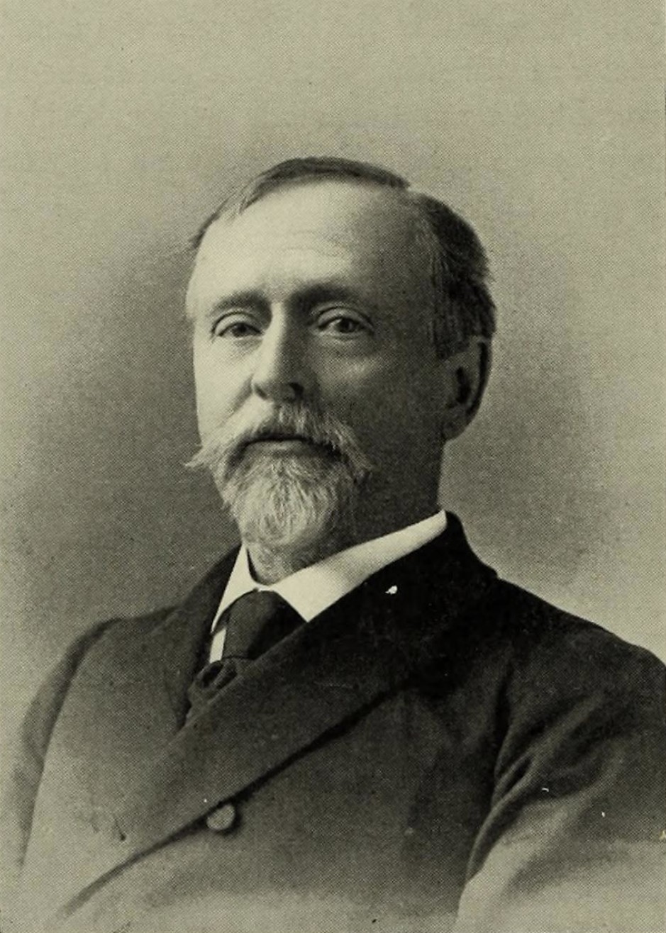 A portrait photograph of Joseph Henry Thayer, a bearded man in a dark suit, the Harvard scholar behind the American edition of the lexicon.