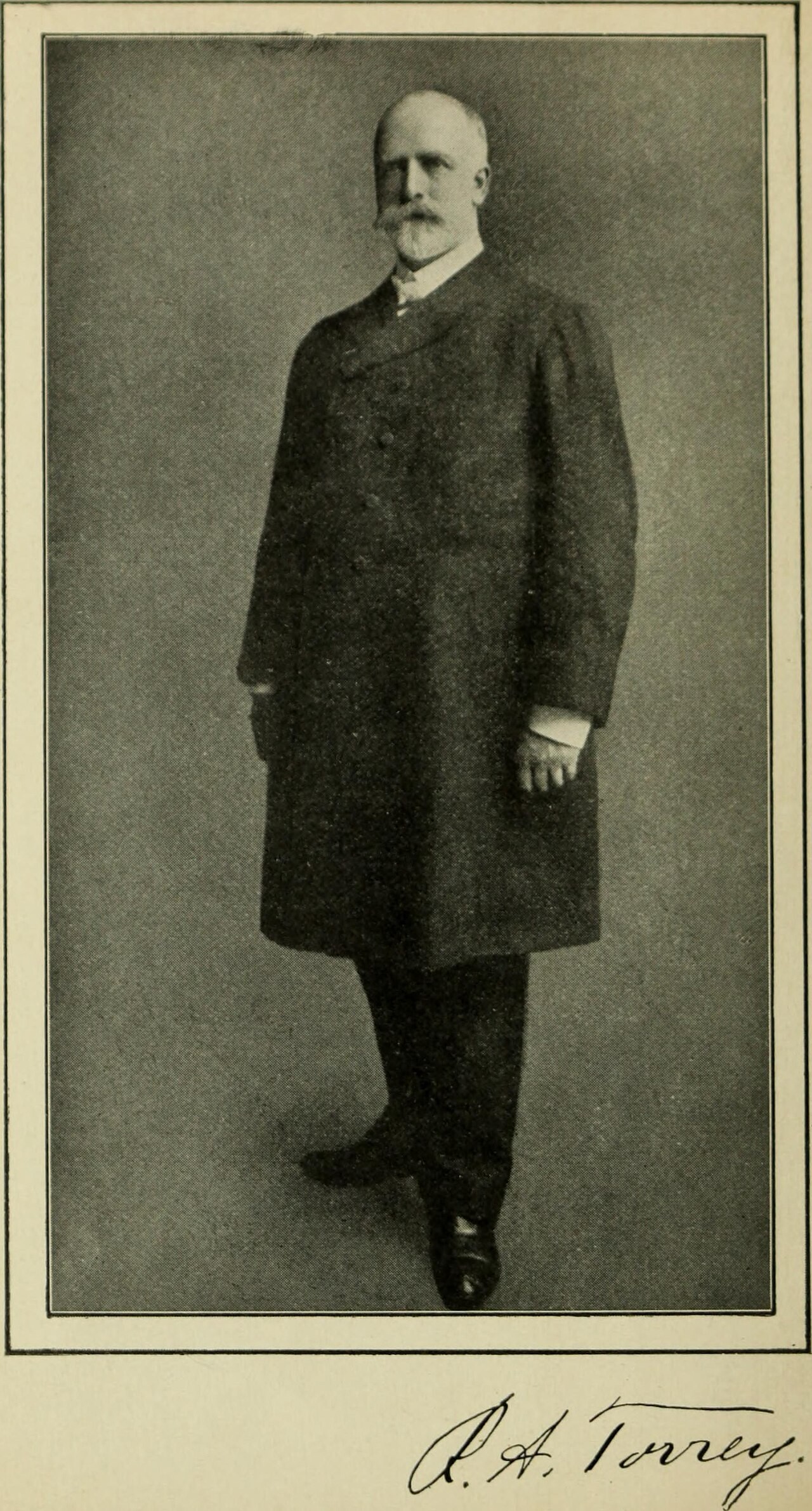 A full-length photographic portrait of R. A. Torrey standing in a long dark coat, with his signature printed beneath, from the 1905 biography Torrey and Alexander.