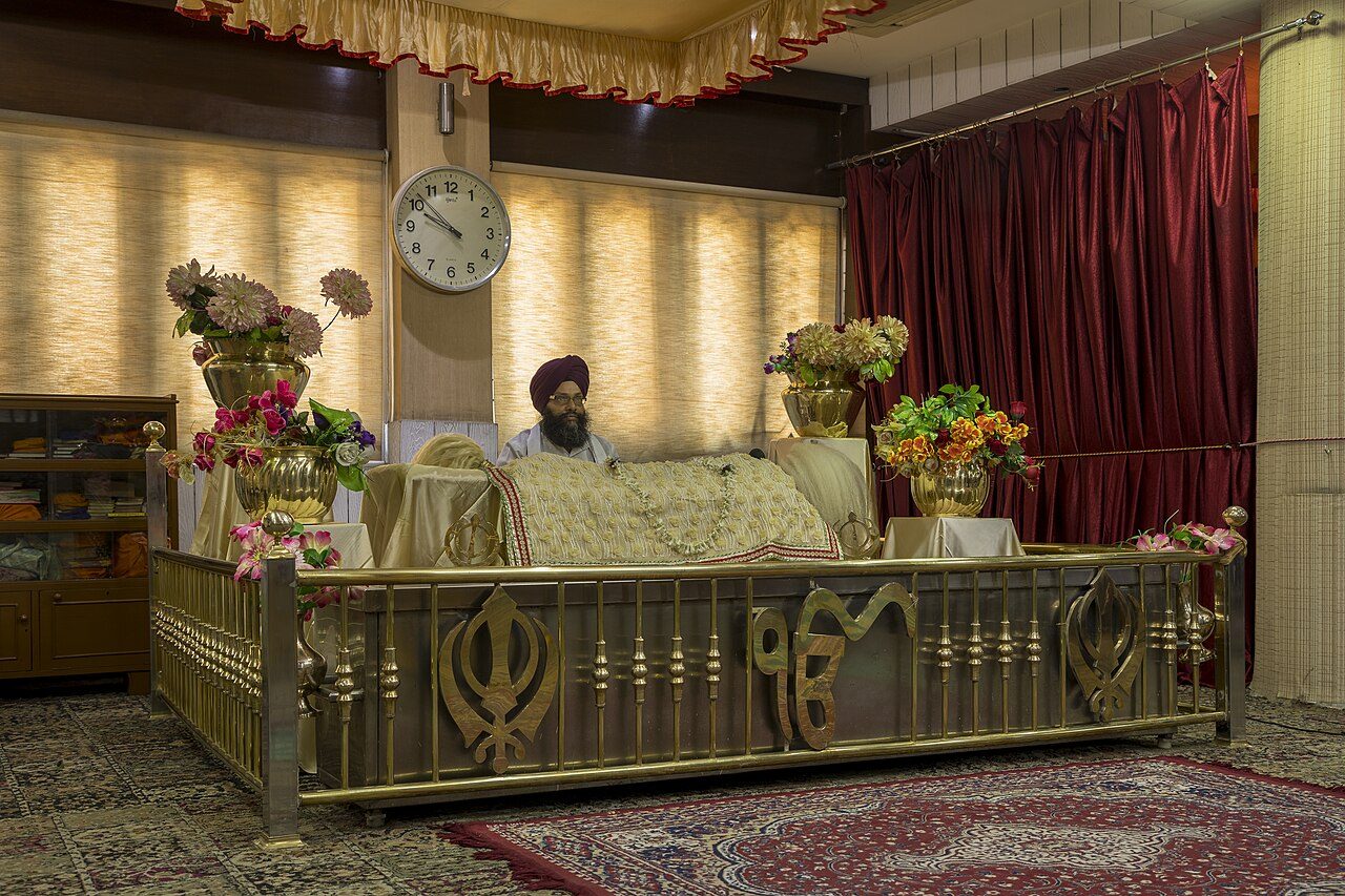 The Guru Granth Sahib enthroned in a gurdwara