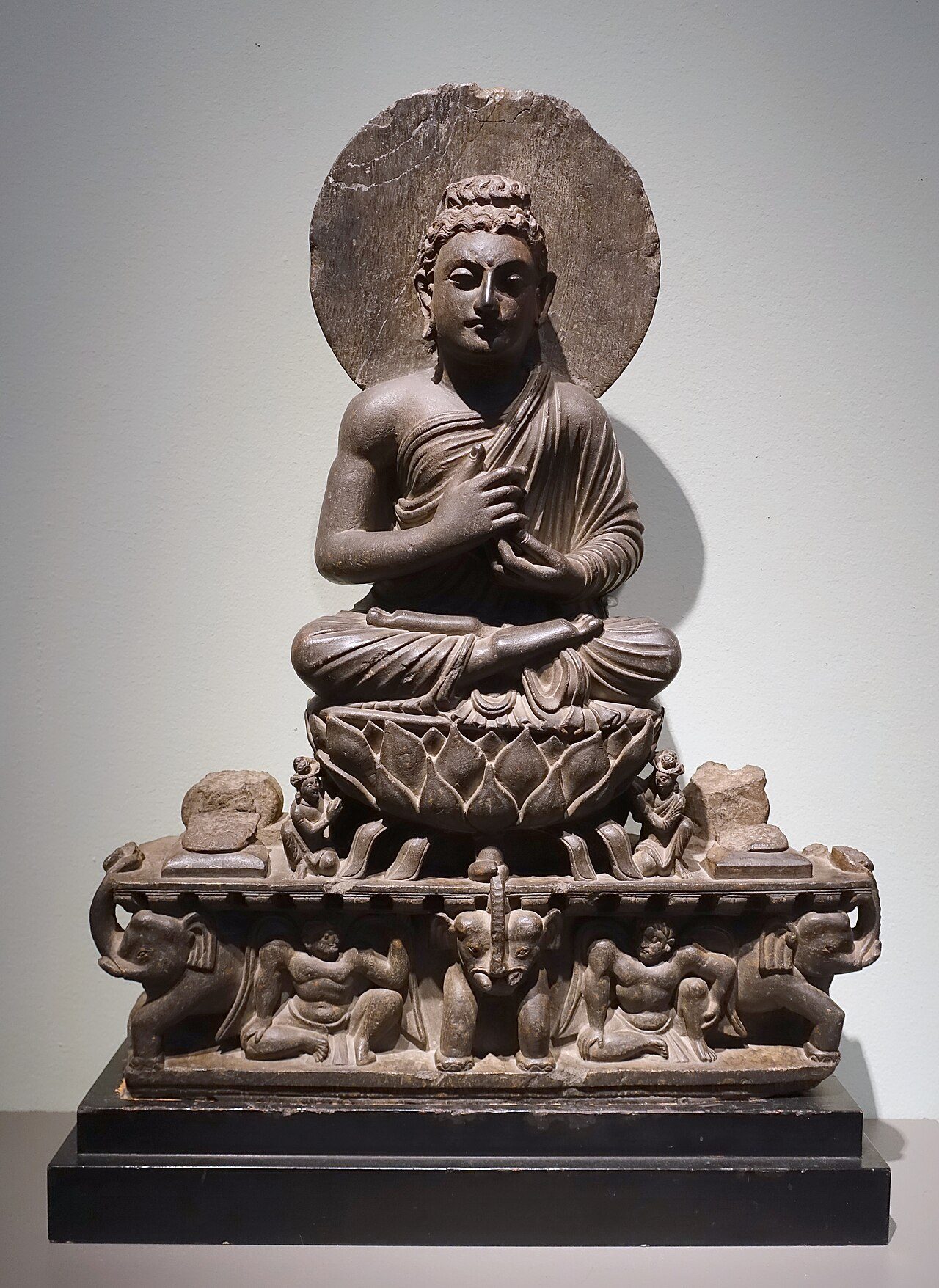 A Gandhara Buddha preaching on a lotus throne