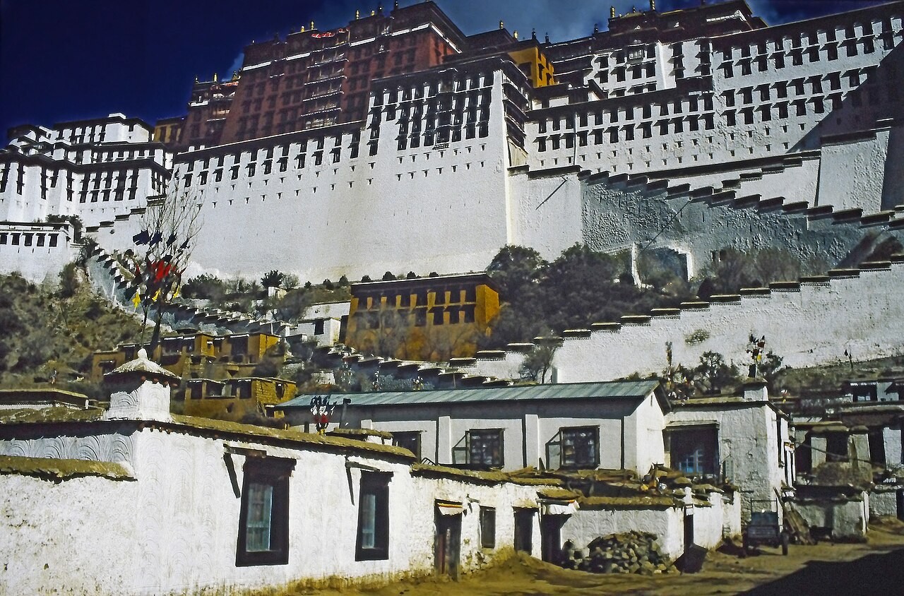 The Potala Palace in Lhasa rising in tiers above the town's whitewashed houses.