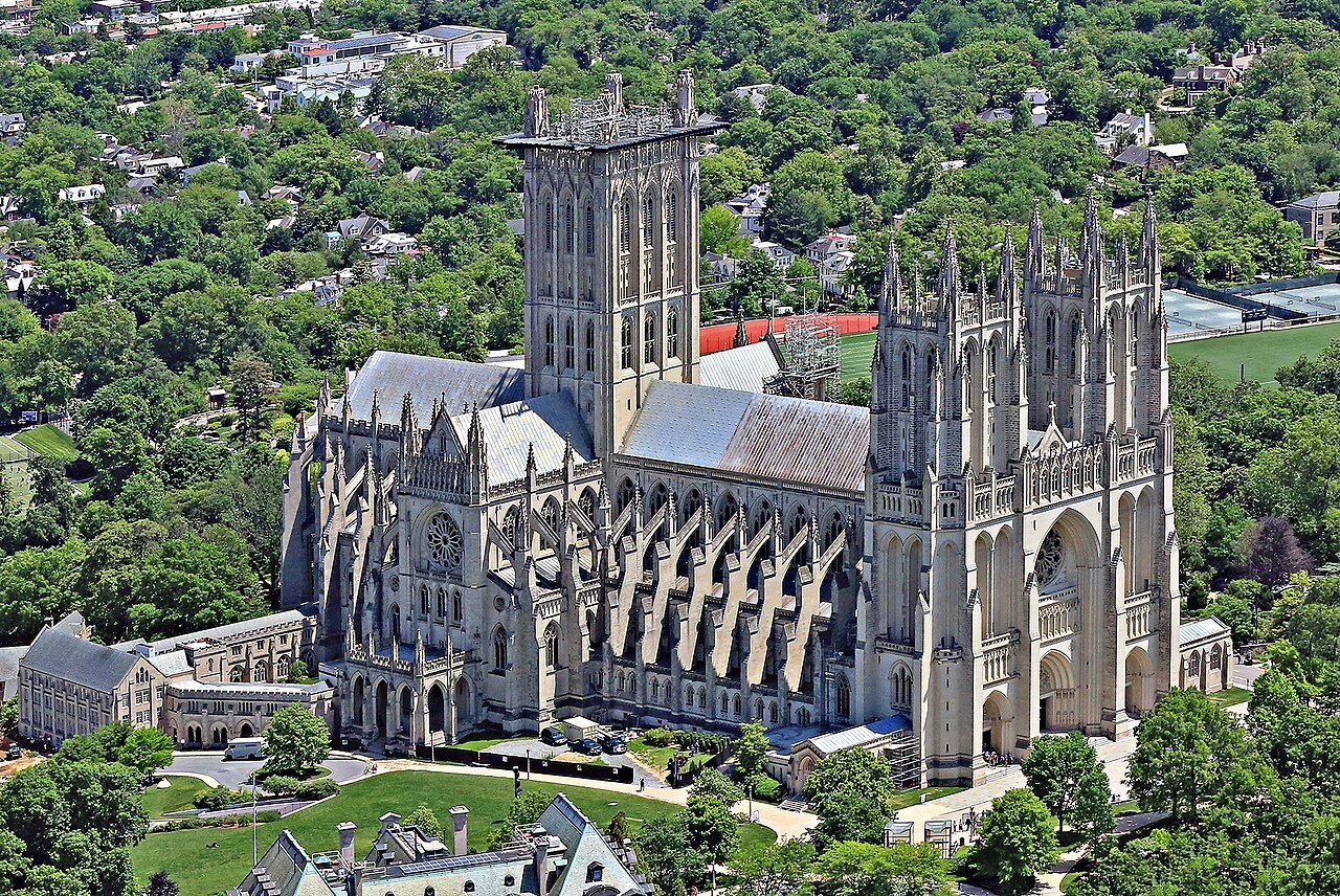 An elevated view of Washington National Cathedral standing among green trees.