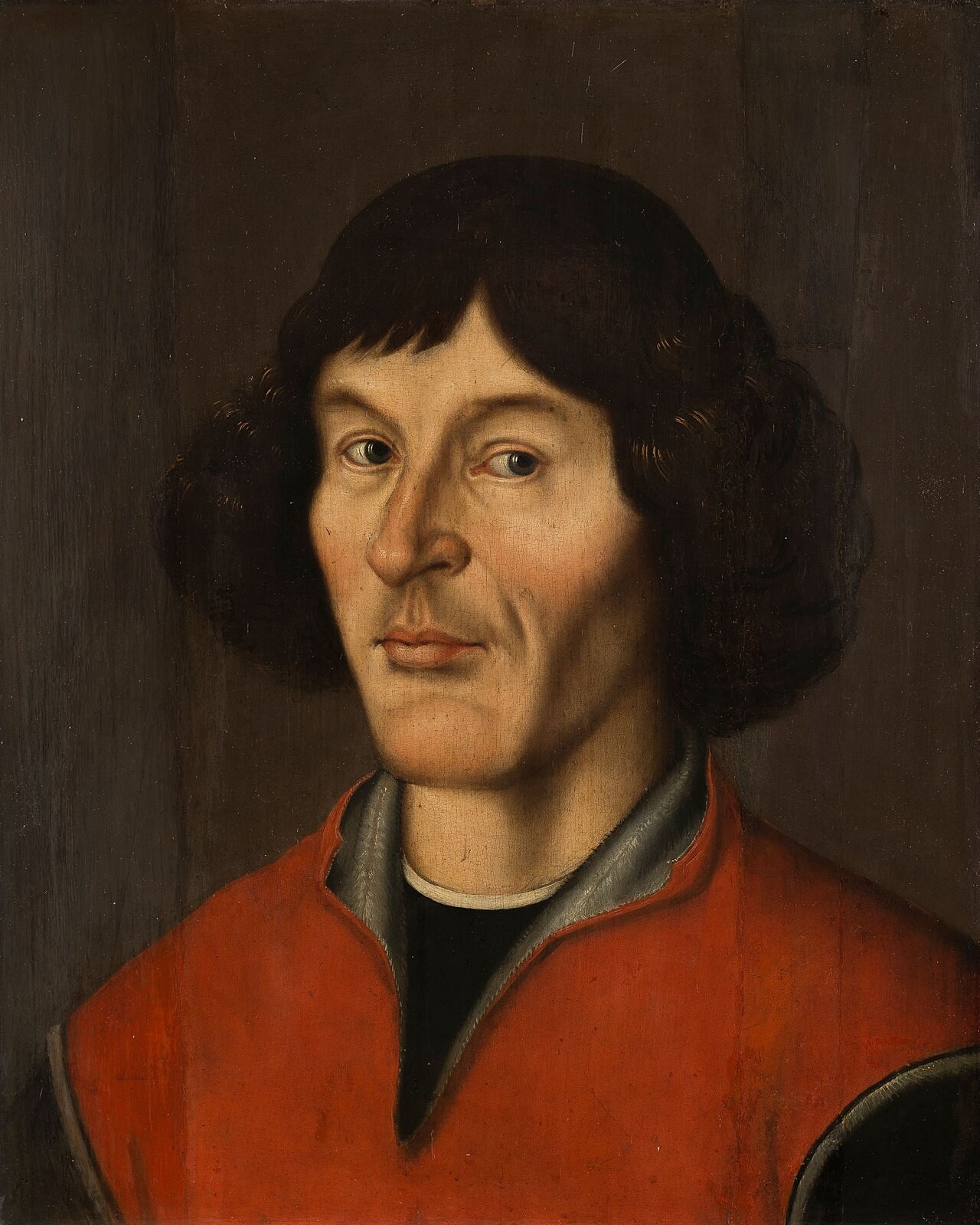 The Toruń portrait of Nicolaus Copernicus, a dark-haired man in a red robe.