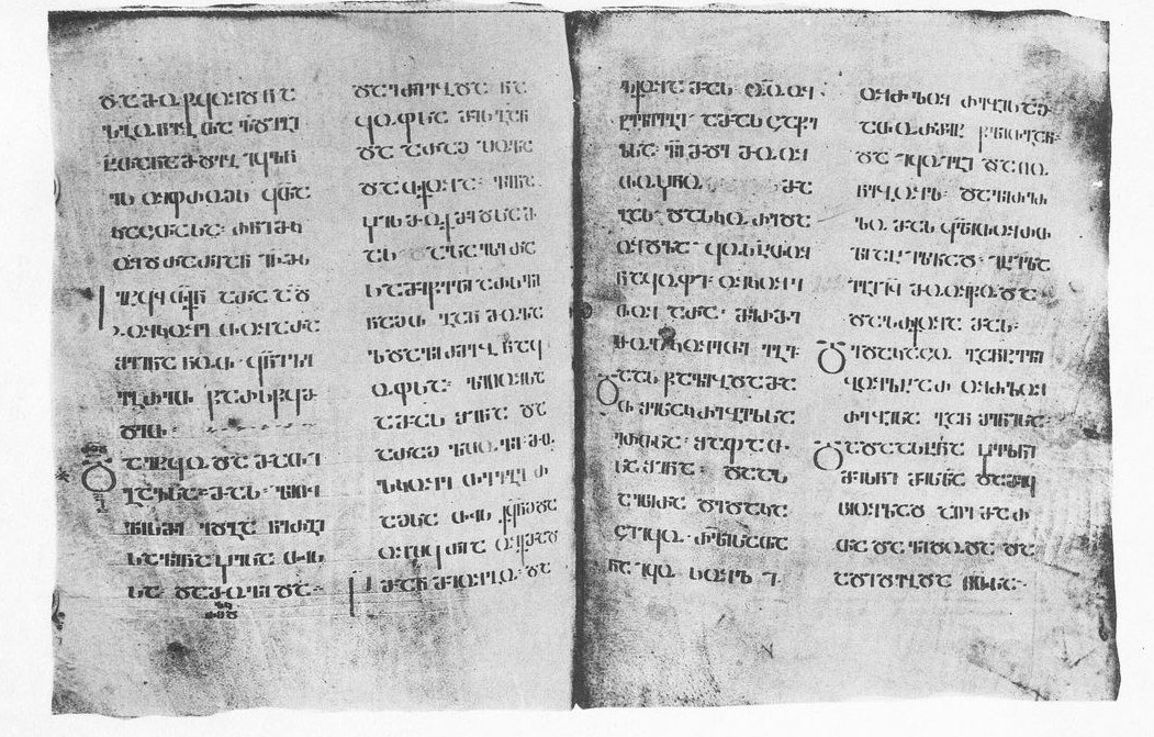 An opening of the Adishi Gospels, its four columns written in Georgian Asomtavruli, the monumental uncial script of Georgia's oldest Gospel book.
