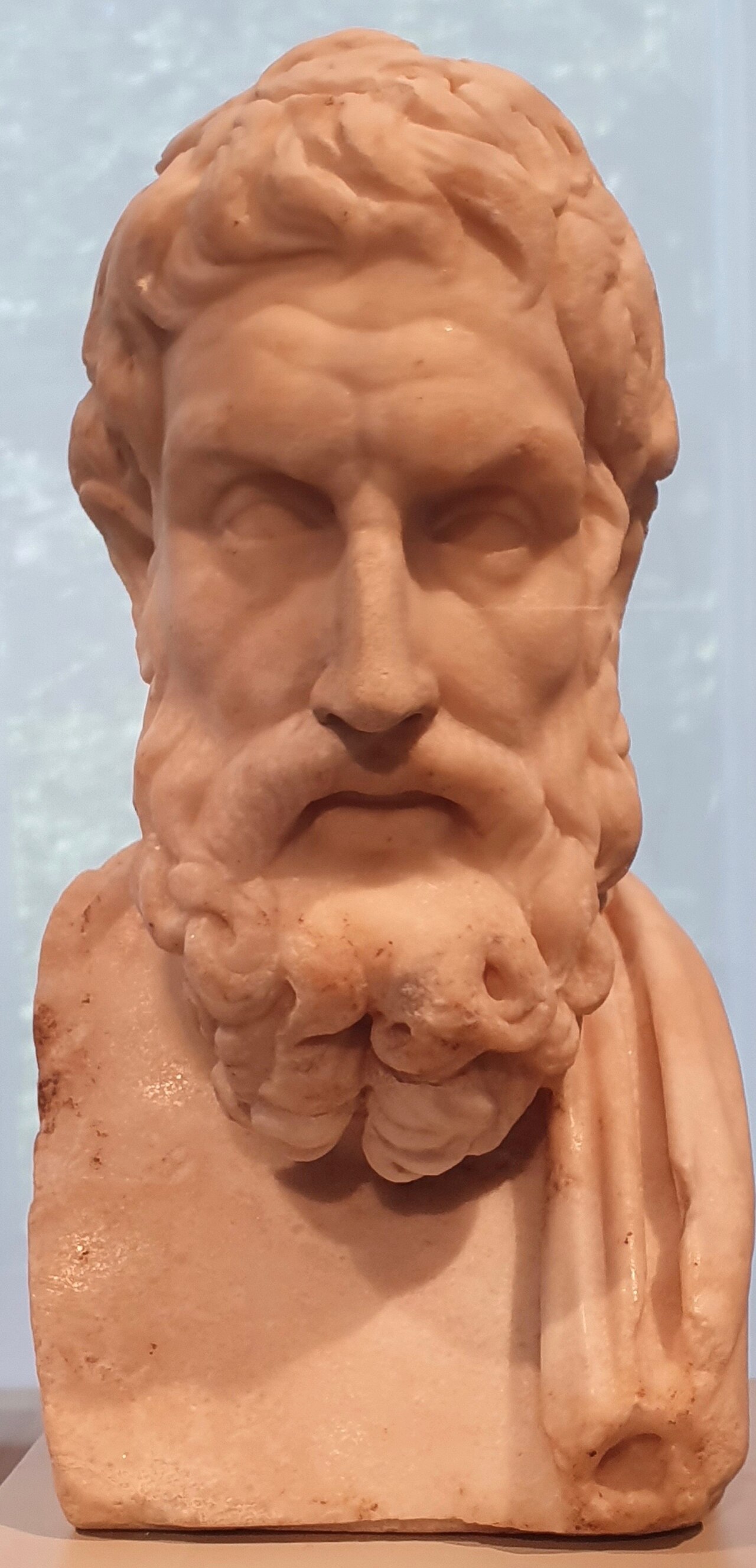 A marble herm bust of Epicurus, his beard forked into thick curls at the chin.