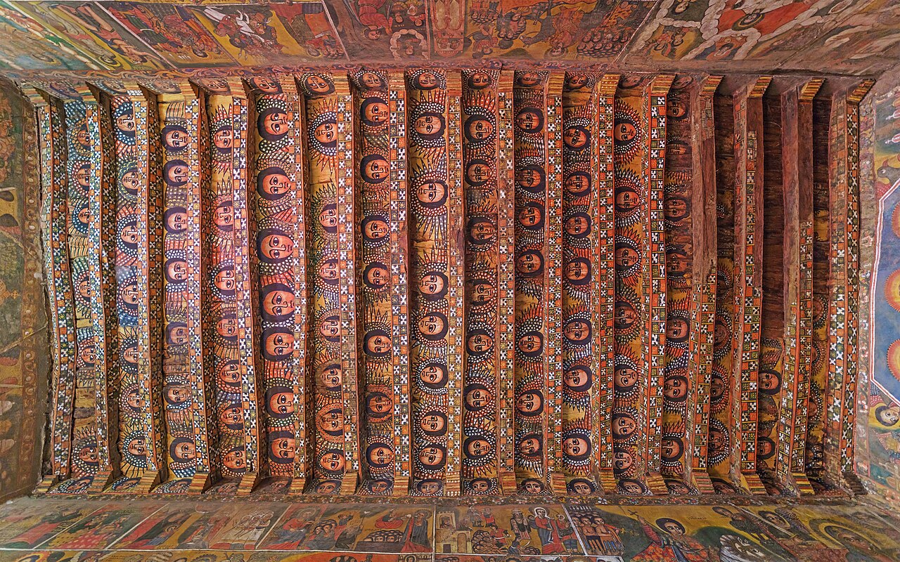 The painted ceiling of Debre Berhan Selassie church in Gondar, Ethiopia: rows of angel faces cover the beams.