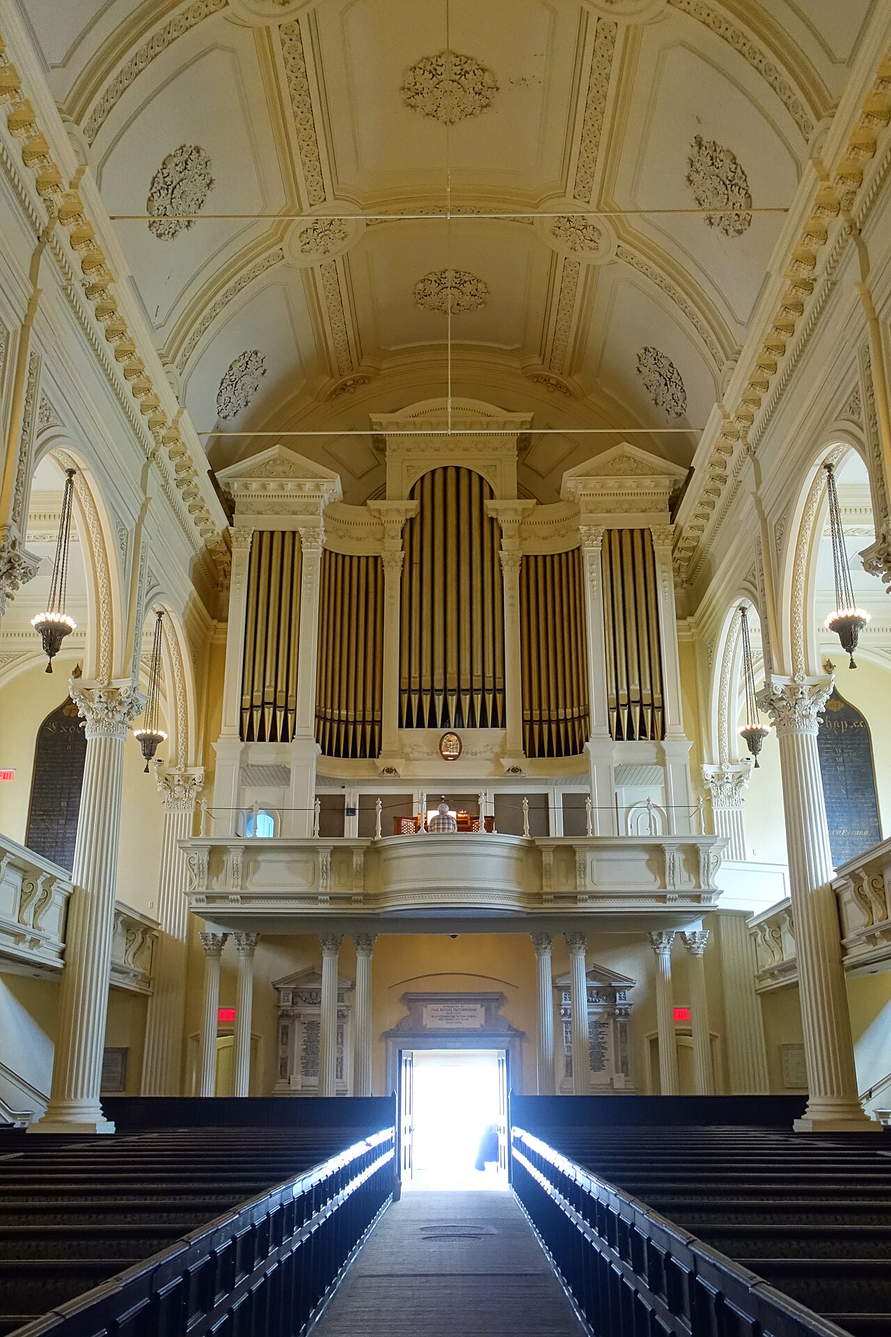 The interior of Arlington Street Church in Boston, its organ and Tiffany windows above the pews.